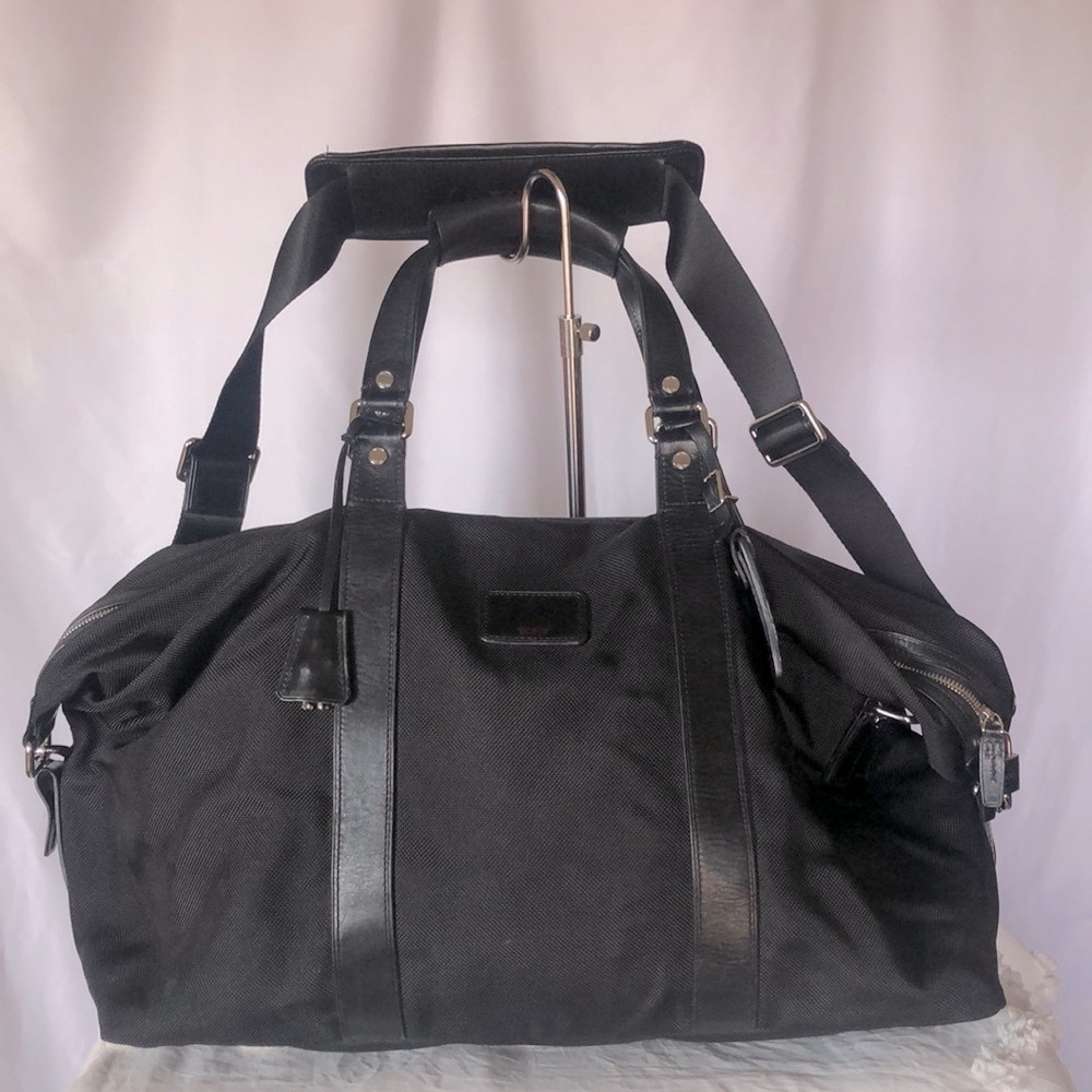 TUMI black Boston 2 way leather and canvas and mini lock. Detachable straps.